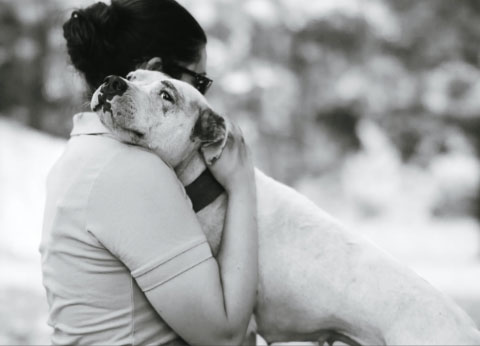 Woman hugging dog